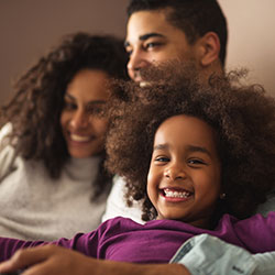 Mom, dad, and daughter smiling